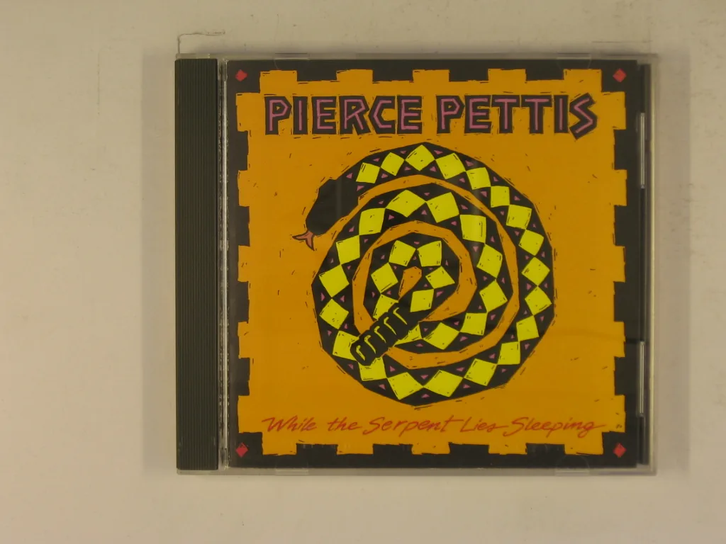 Copertina di While The Serpent Lies Sleeping