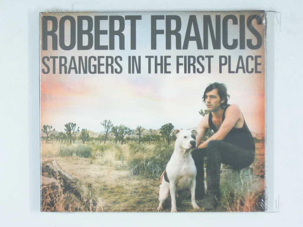 Copertina di Strangers In The First Place