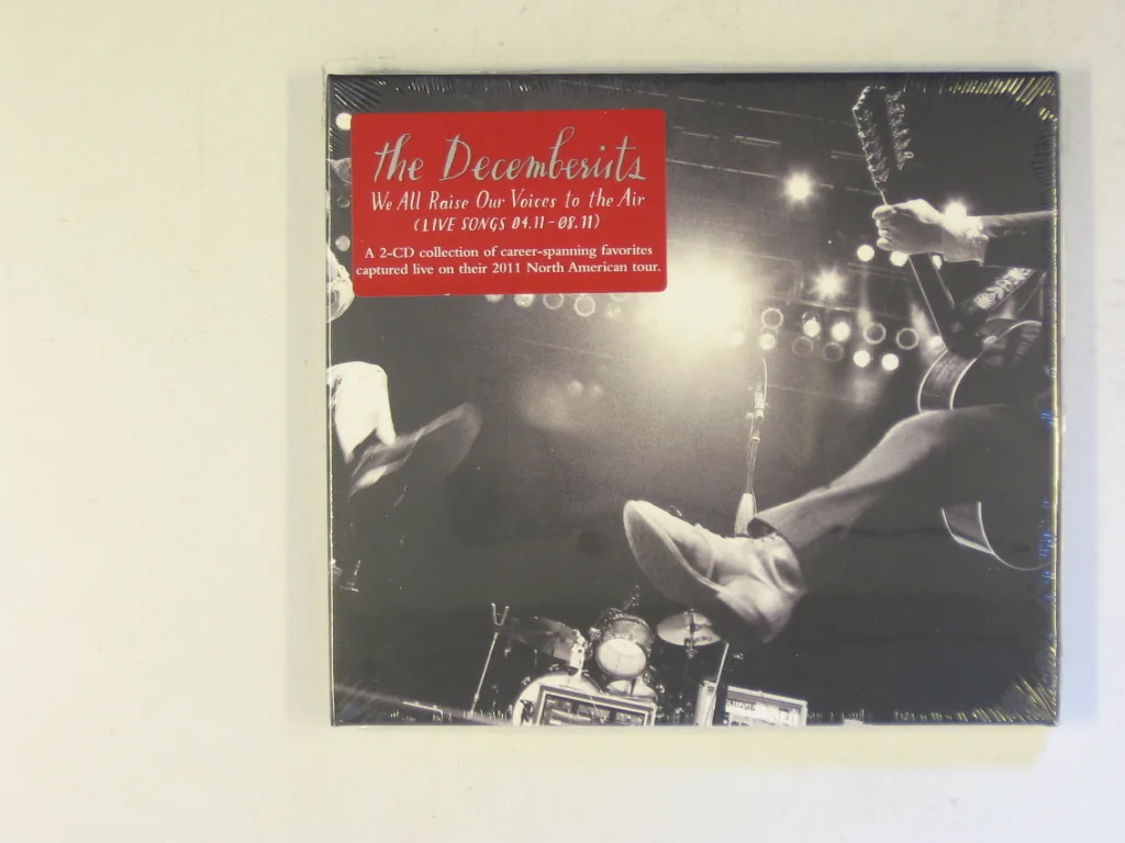 Copertina di We All Raise Our Voices To The Air (Live Songs 04.